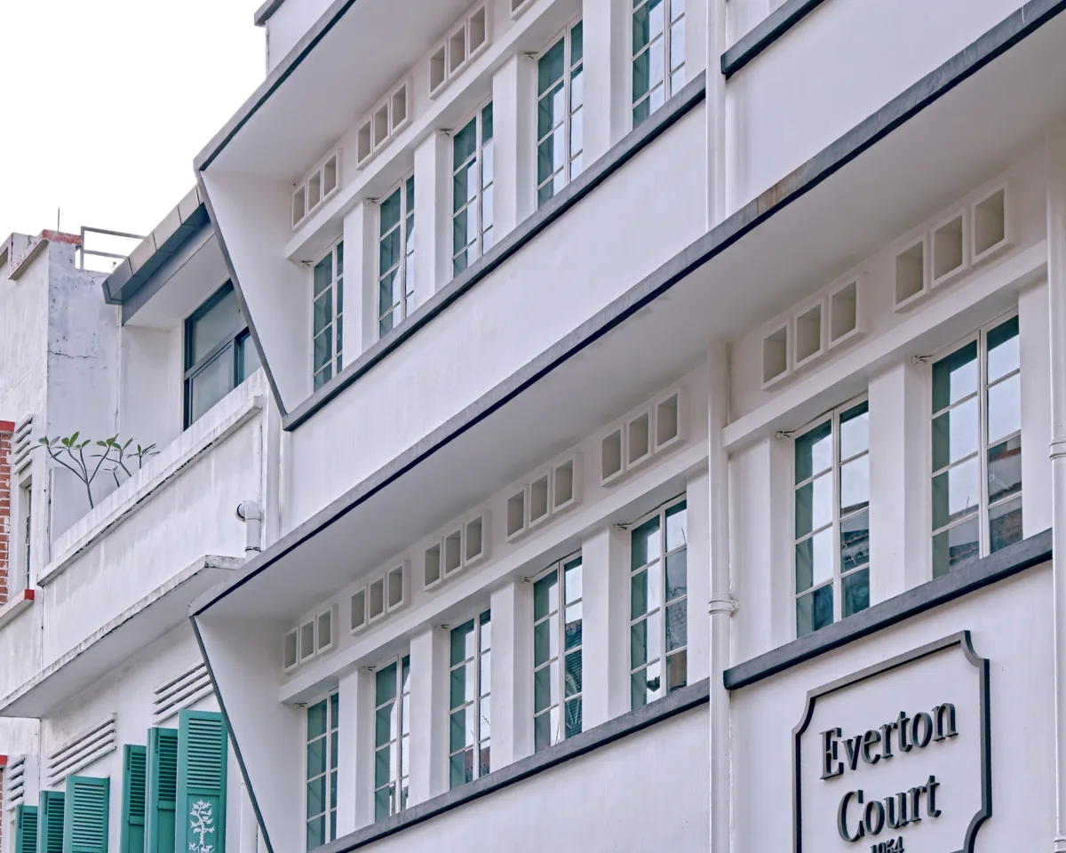 White Everton Court heritage facade with teal windows in Everton Park