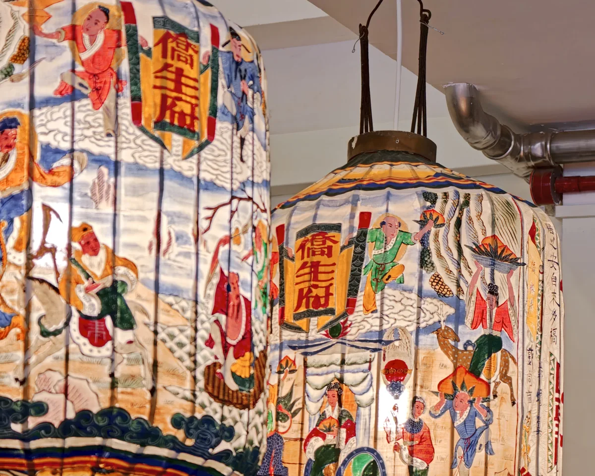 Painted Peranakan lanterns with traditional figures and calligraphy